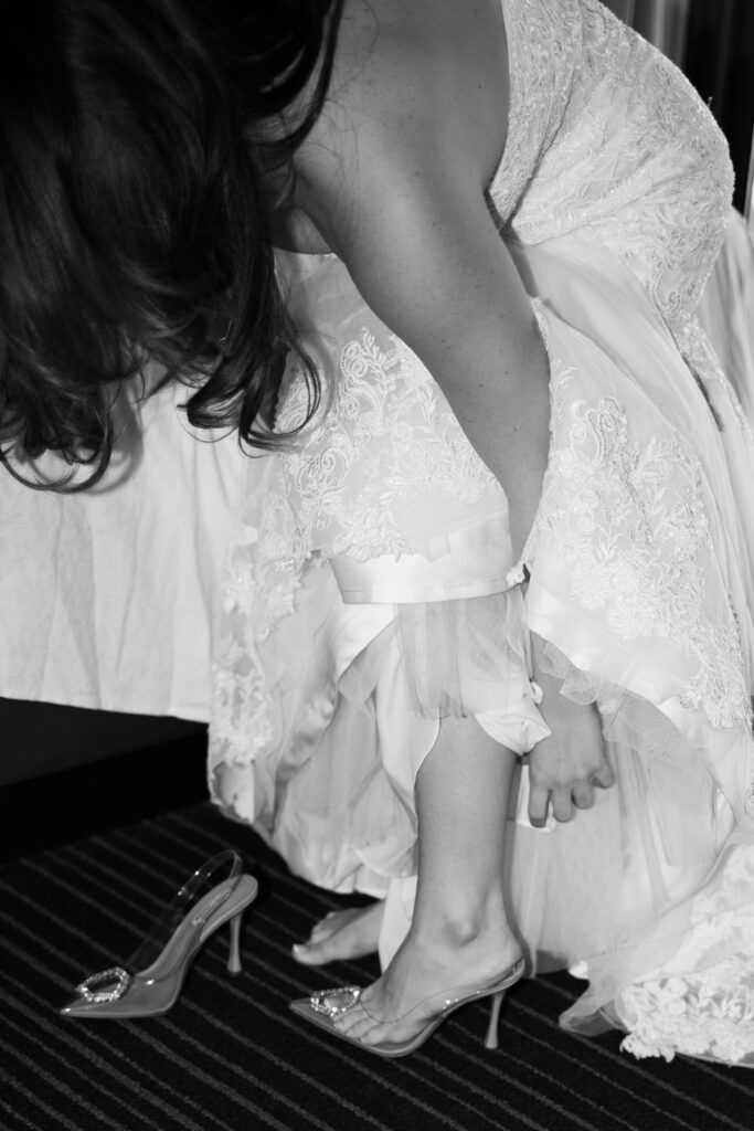 Bride putting her heels on