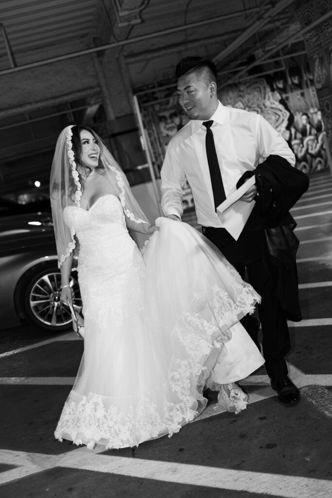 Bride and groom walking in a parking garage
