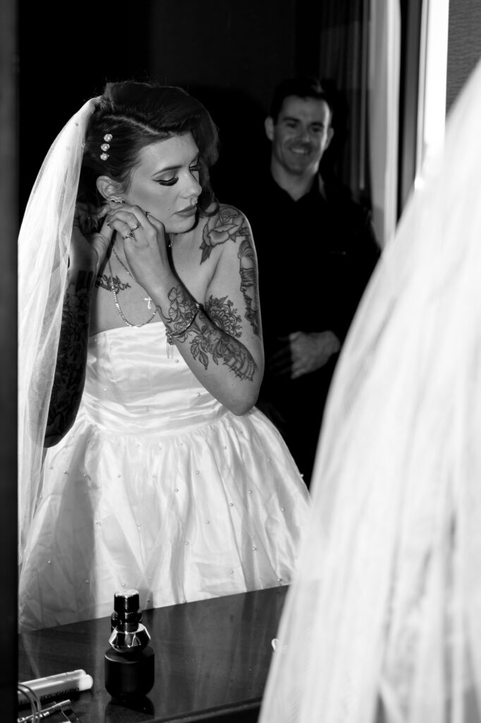 Bride and groom getting ready in hotel room together