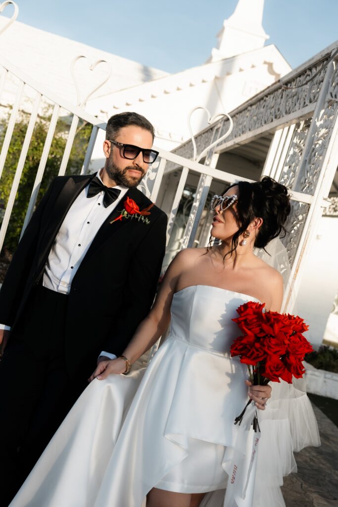 Couple posing outside of Little White Wedding Chapel in Las Vegas.