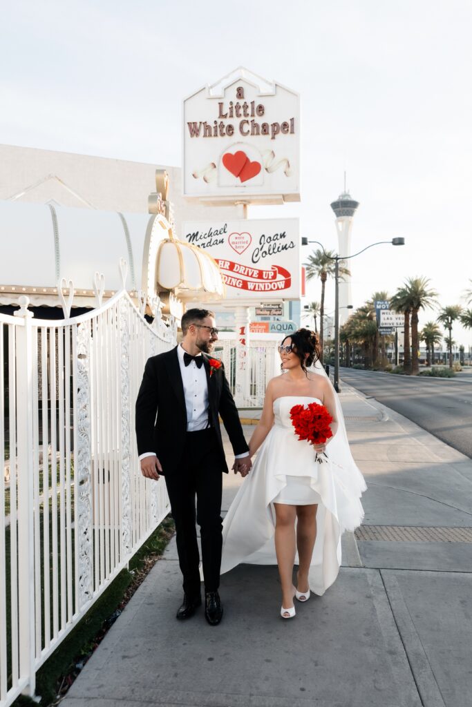 Couple posing outside of Little White Wedding Chapel in Las Vegas.