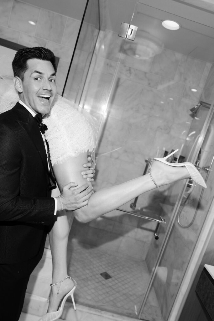Flash portrait of a groom carrying his bride during their Las Vegas elopement. 