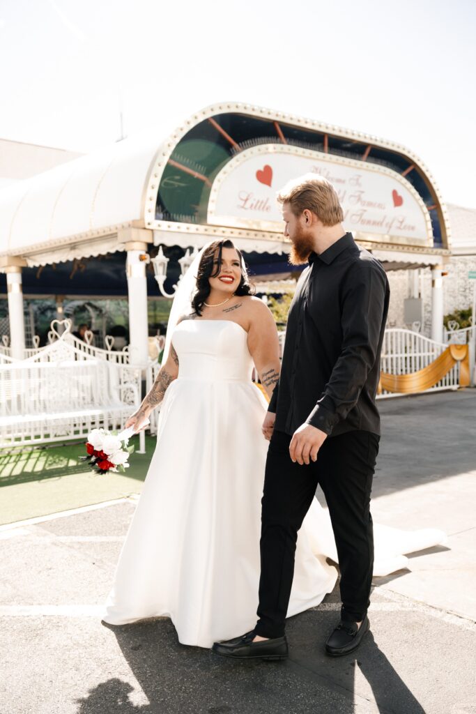 Bride and groom posing for photos outside of The Little White Chapel during their Vegas elopement