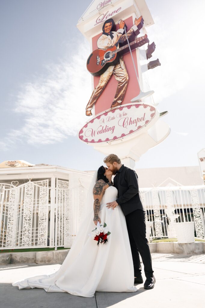 Bride and groom posing for photos outside of The Little White Chapel during their Vegas elopement