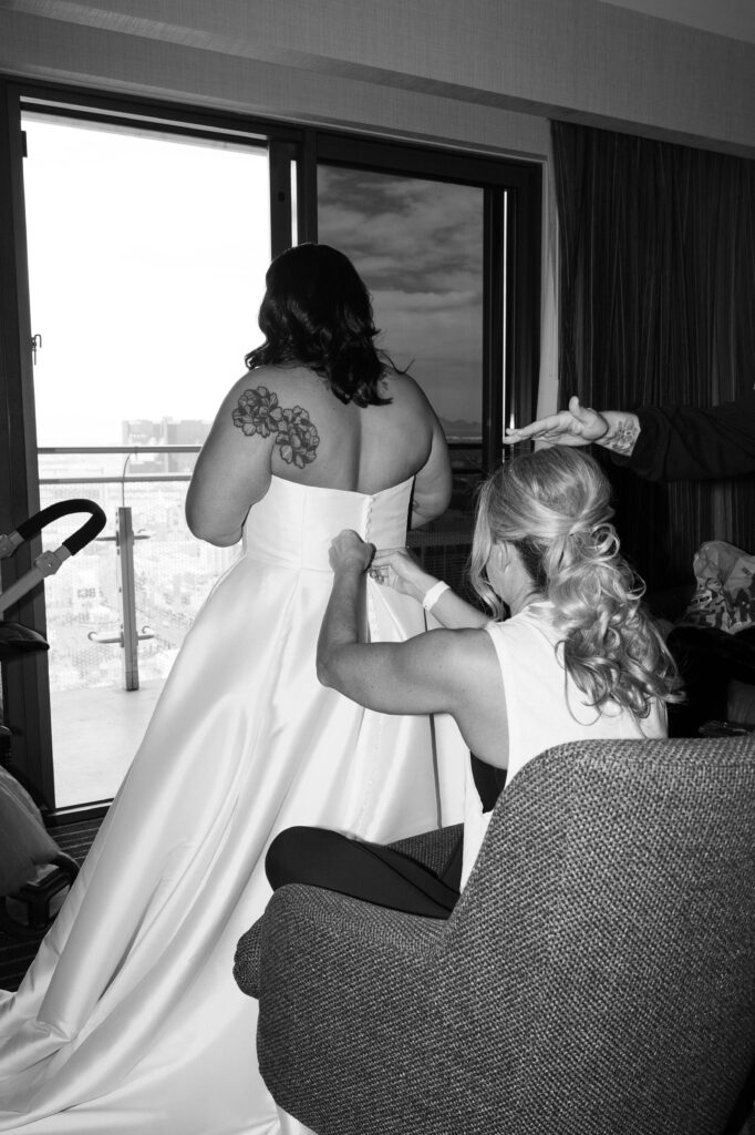 Bride getting her wedding dress on
