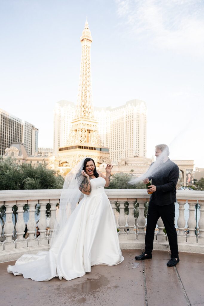 Bride and groom popping champagne in Vegas