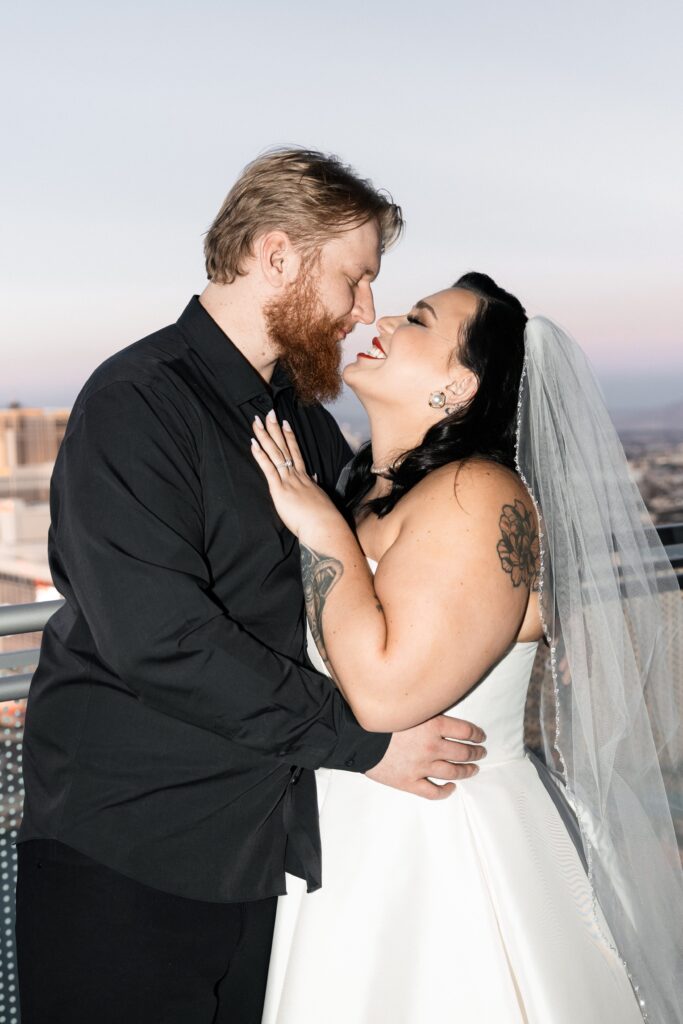 Bride and groom posing on the balcony of The Cosmopolitan Hotel during their Vegas elopement 