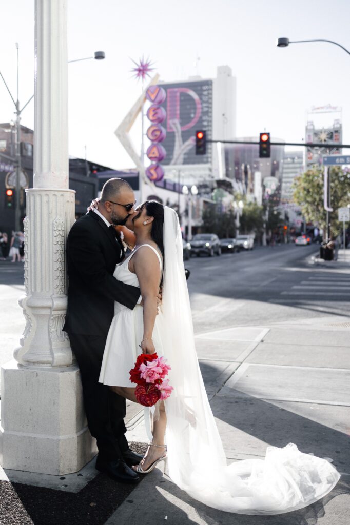 Bride and groom walking down Fremont Street in Las Vegas