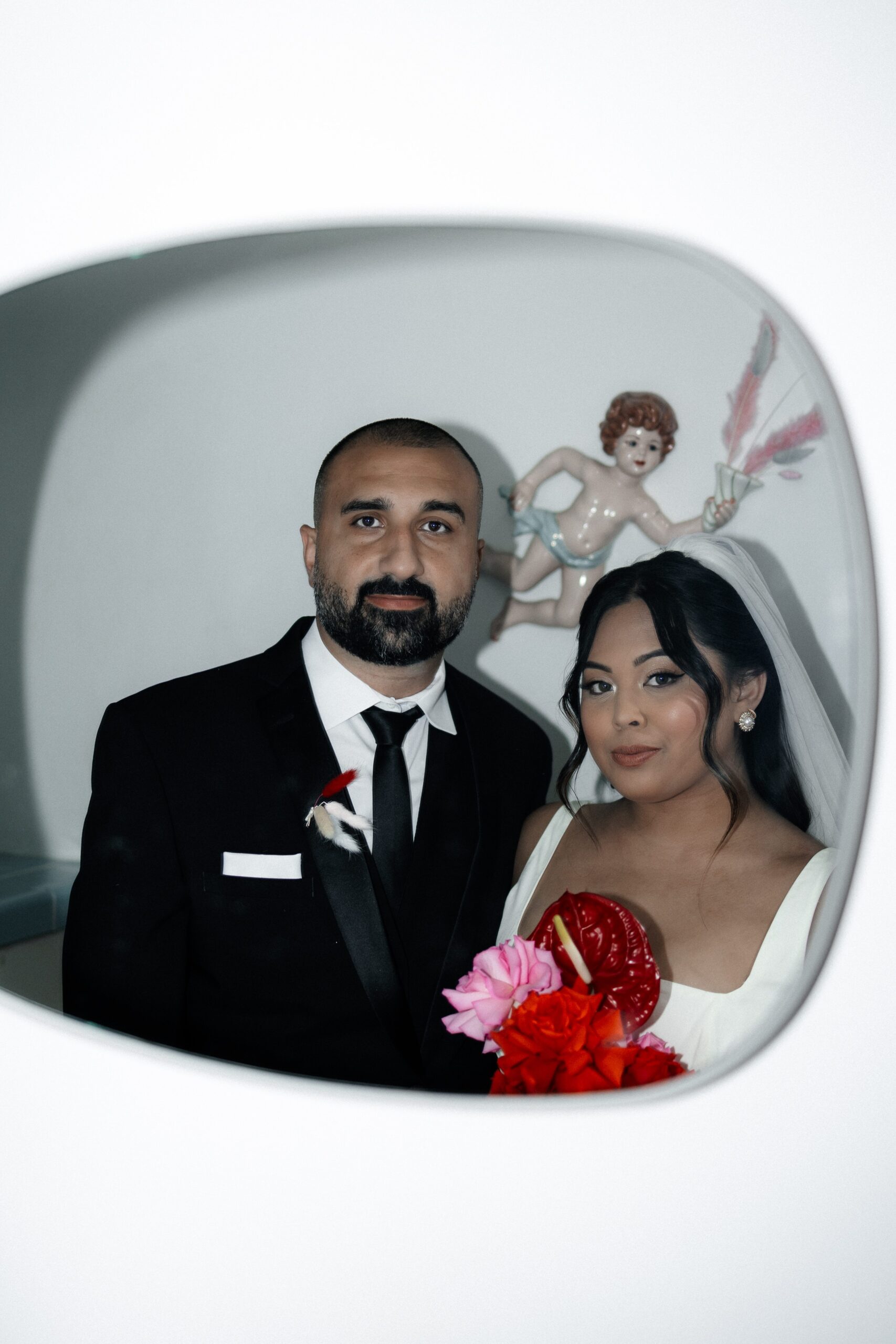 Bride and groom looking in the mirror at Sure Thing Chapel in Las Vegas