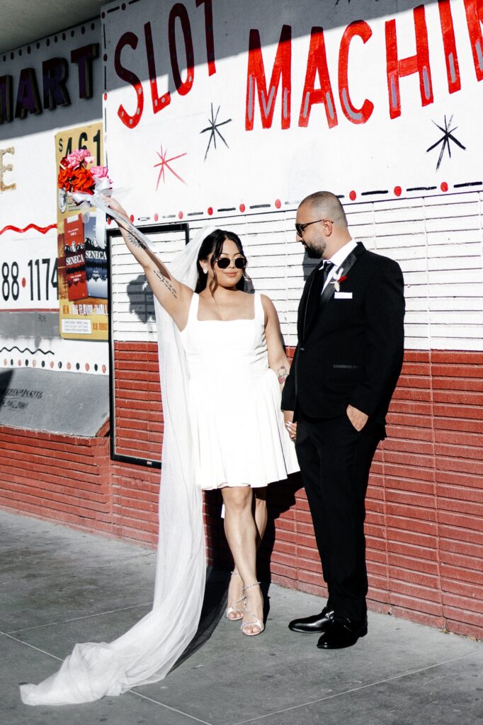 Couple posing for photos outside of a Vegas convenience store  