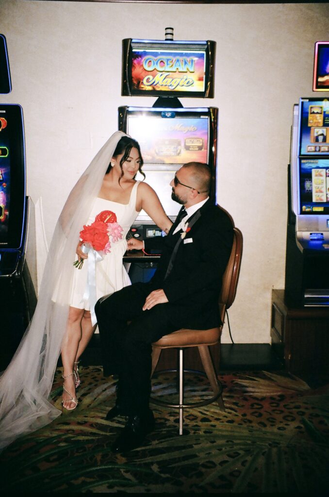 Couple taking photos in a Vegas casino on film