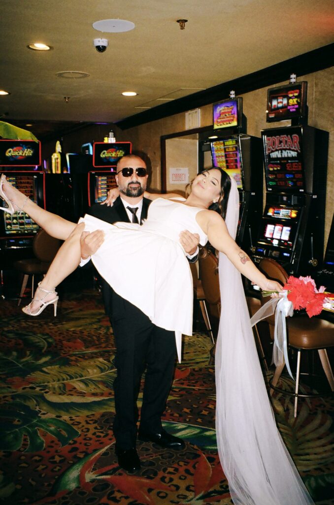 Couple taking photos in a Vegas casino on film