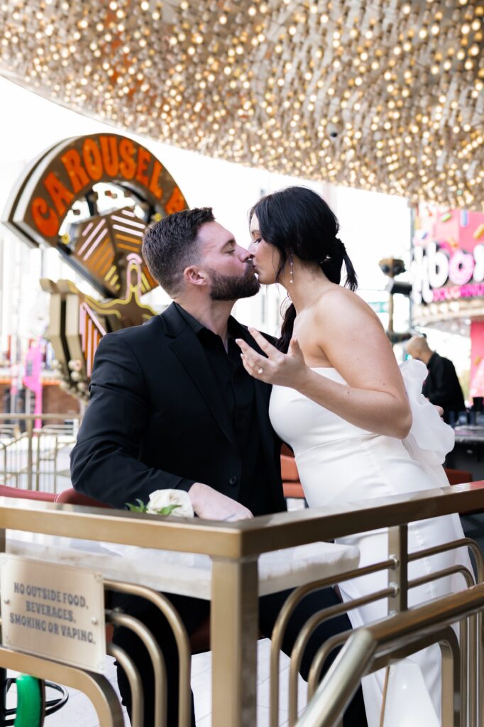 Bride and groom taking tequila shots at Carousel Bar in Vegas