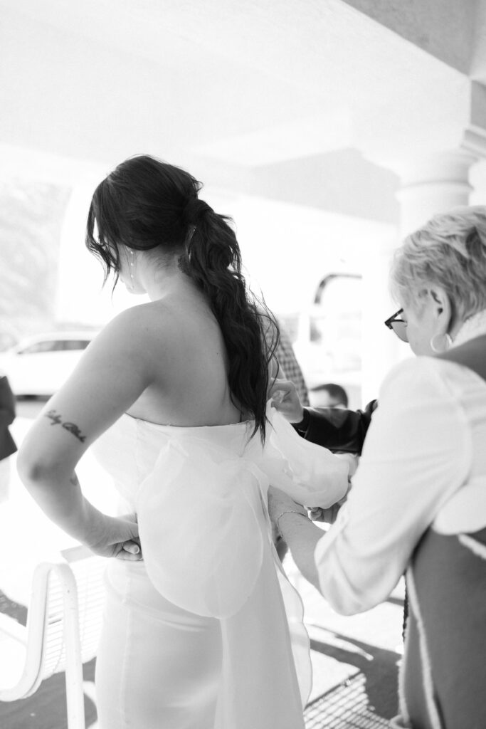 Bride getting her dress zipped up