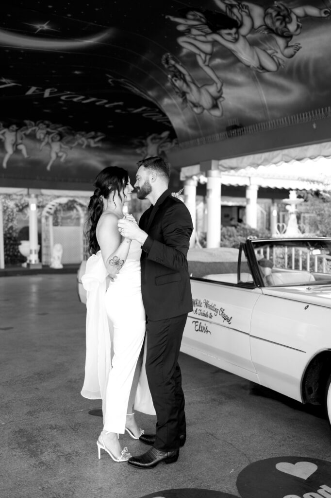 Bride and groom dancing in front of the Pink Cadillac at The Little White Chapel