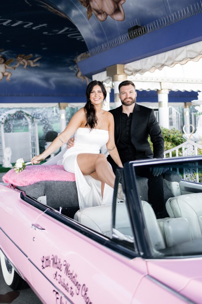 Bride and groom sitting in the Pink Cadillac for their elopement in Las Vegas