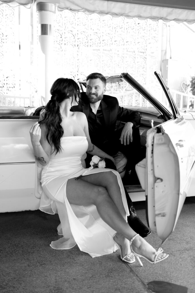 Bride and groom sitting in the Pink Cadillac for their elopement in Las Vegas