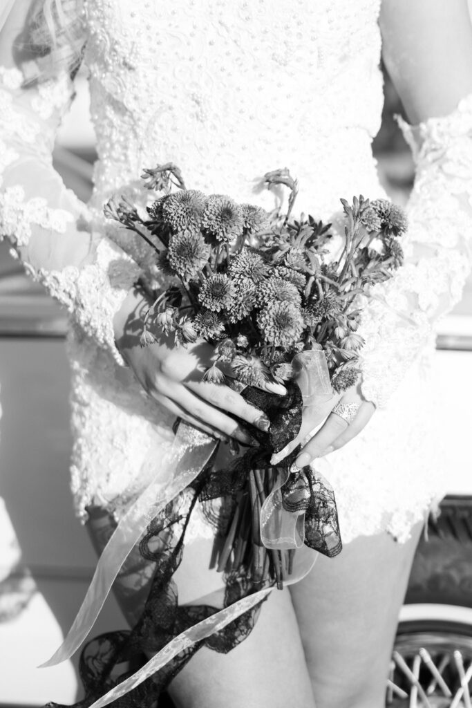 Black and white photo of a bride holding a bouquet