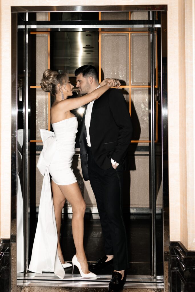 Flash photo of a bride and groom posing in an elevator at The Cosmopolitan Hotel in Las Vegas
