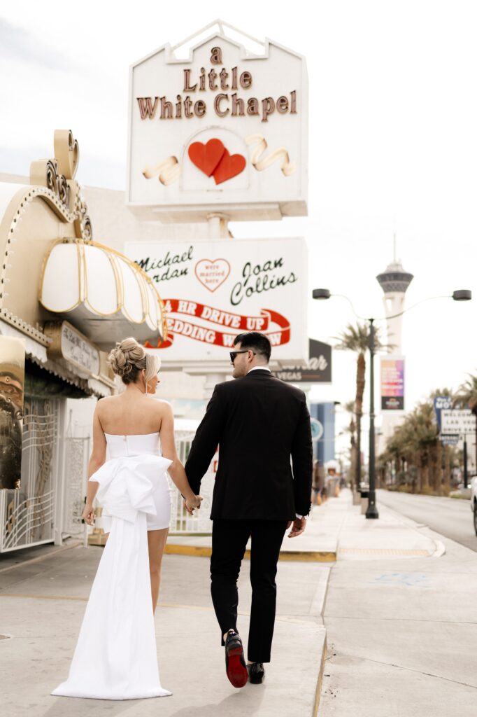 Bride and groom walking to The Little White Chapel during their elopement in Vegas