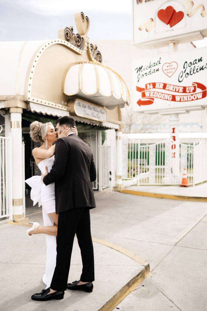 Bride and groom kissing in front of The Little White Chapel during their elopement in Vegas