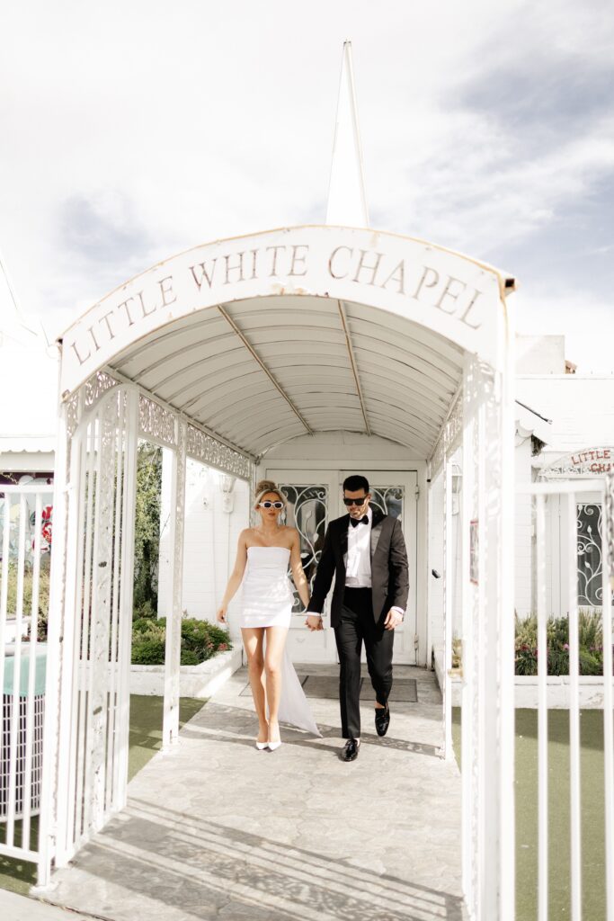Bride and groom walking out of The Little White Chapel during their elopement in Vegas