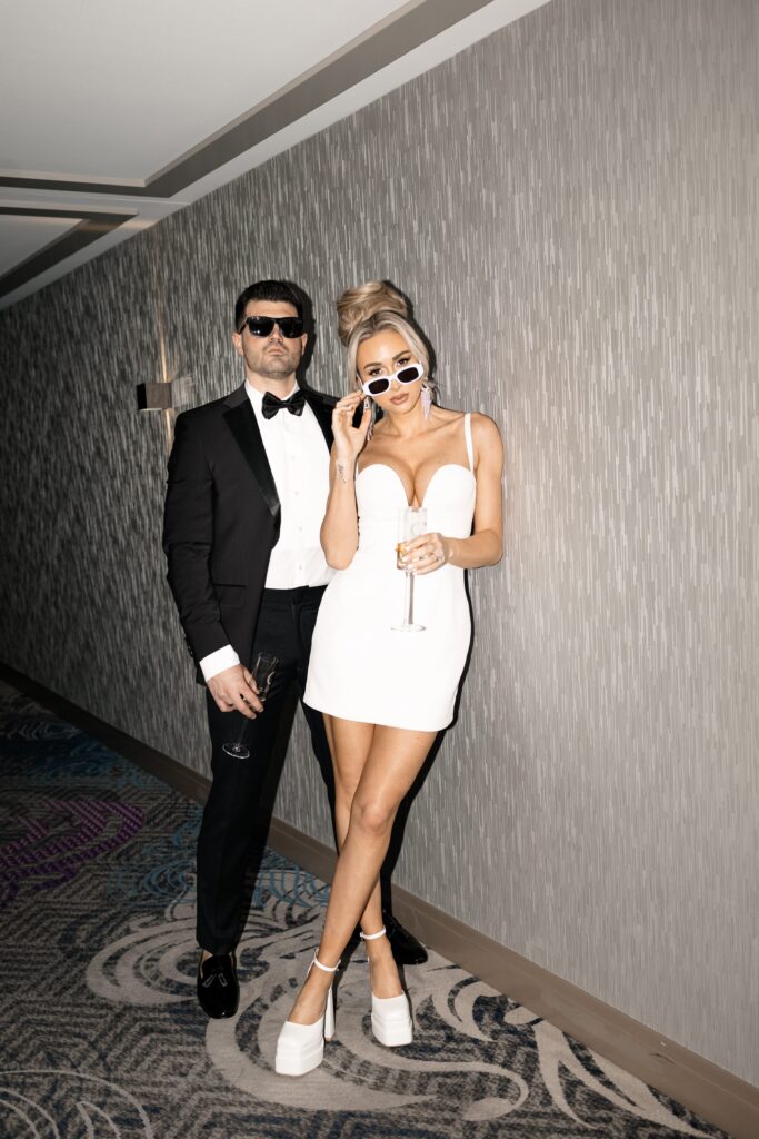 Flash photos of a bride and groom in the hallways of The Cosmopolitan Hotel in Las Vegas wearing sunglasses.