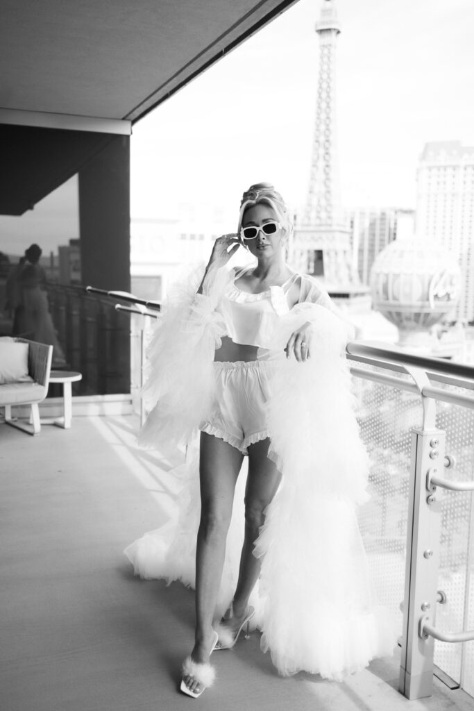 Black and white photo of a bride posing for photos on The Cosmopolitan deck in Las Vegas
