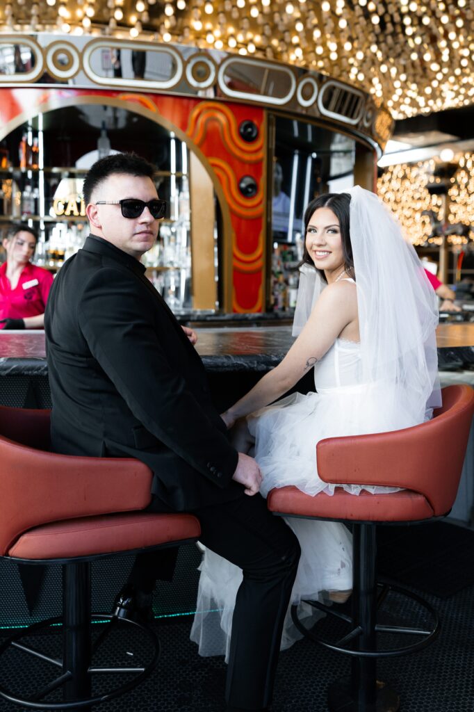 Bride and groom getting drinks at The Carousel Bar at Plaza in Las Vegas