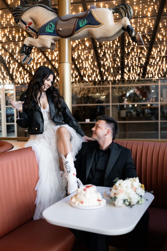 Bride and groom eating their cake by Lucky Me Cakery at The Carousel Bar at The Plaza in Las Vegas