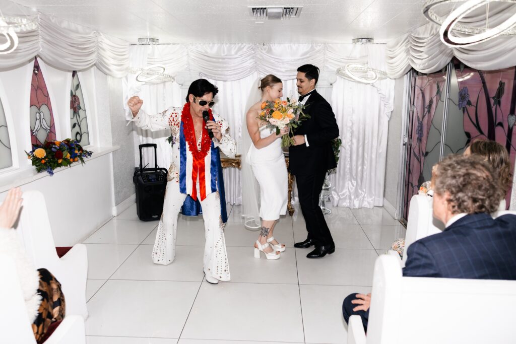 Bride and groom during Elvis' performances at The Little White Chapel