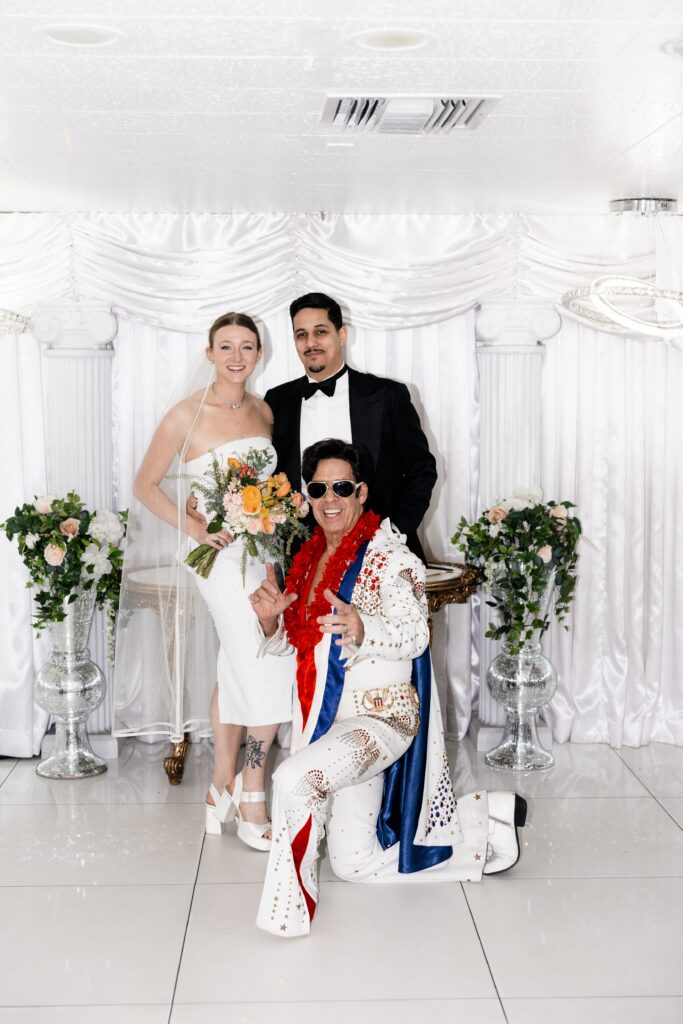 Bride and grooms portraits with Elvis impersonator at The Little White Chapel