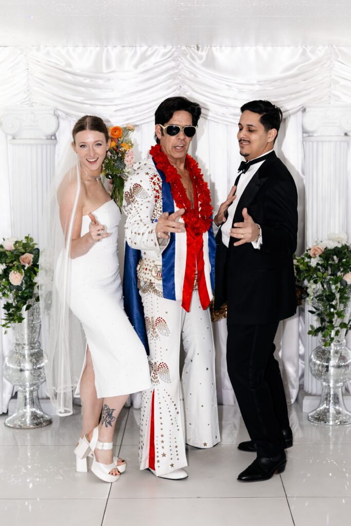 Bride and grooms portraits with Elvis impersonator at The Little White Chapel