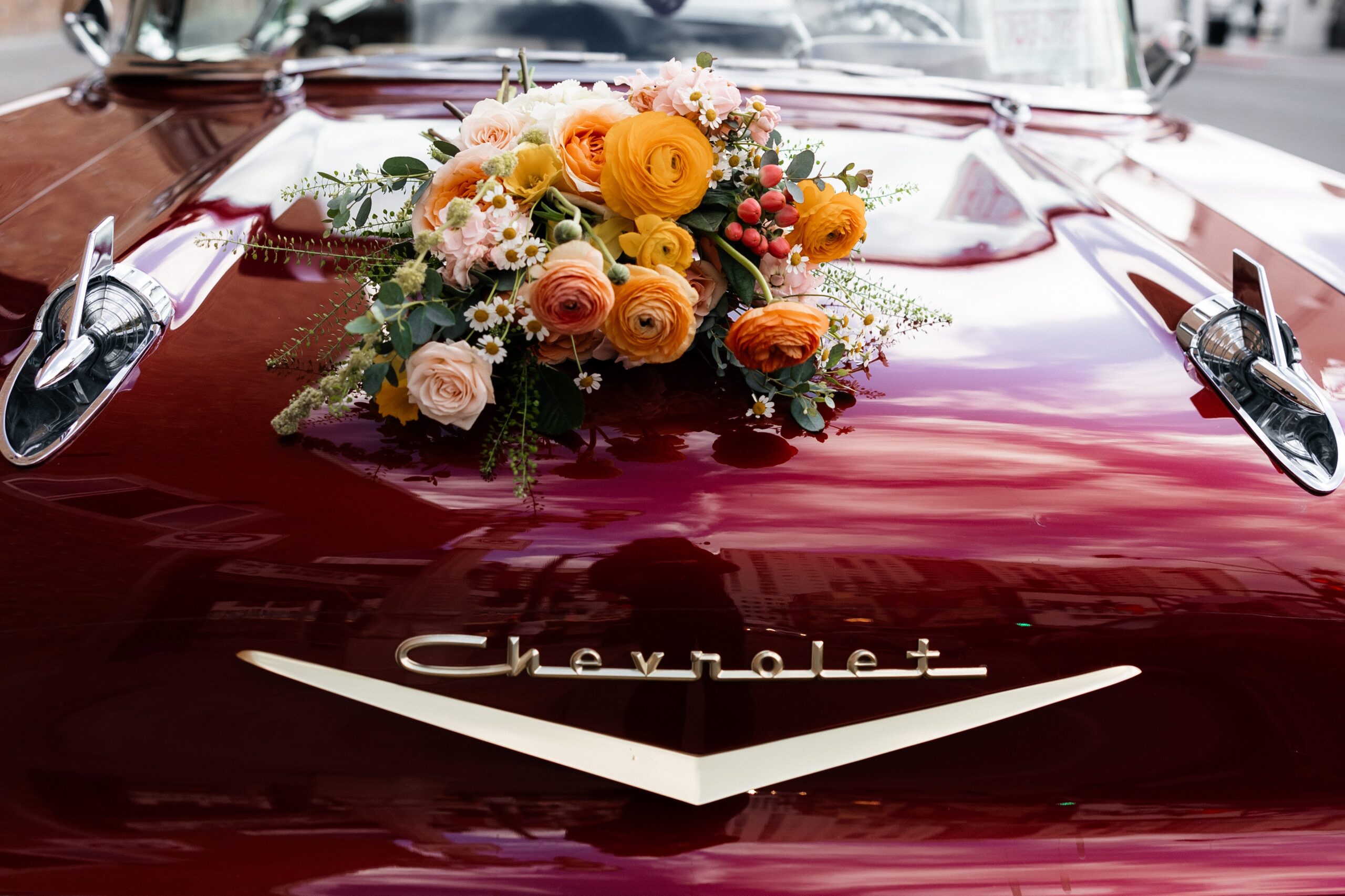 Las Vegas elopement wedding bouquet on top of a classic cherry red Chevrolet. 