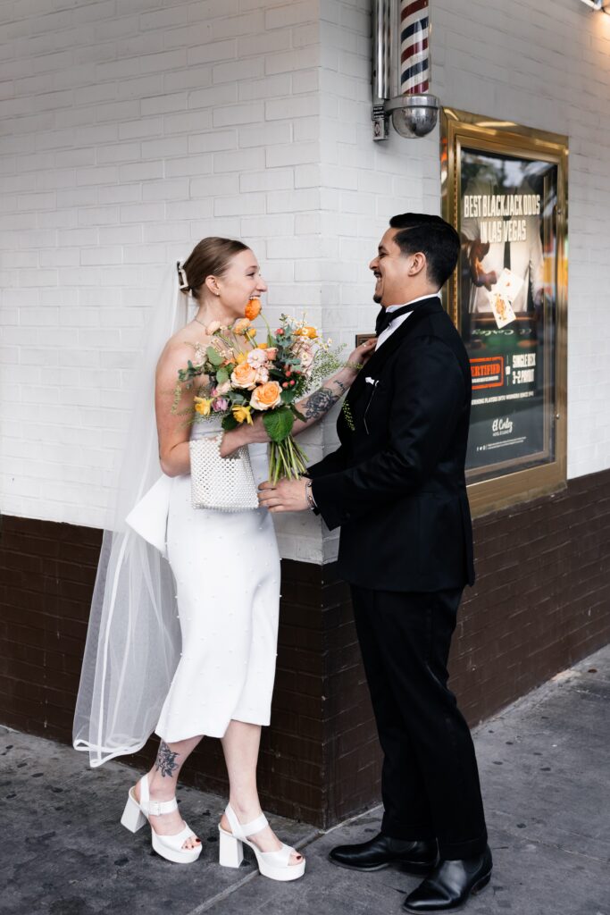 Bride and groom, sharing their first looks at the corner of El Cortez Hotel and Fremont Street in Las Vegas