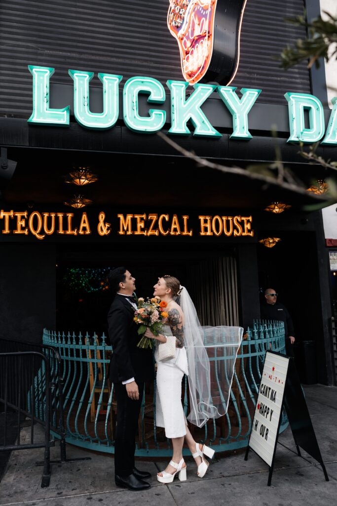 Bride and groom portraits in front of Lucky Day bar in Las Vegas