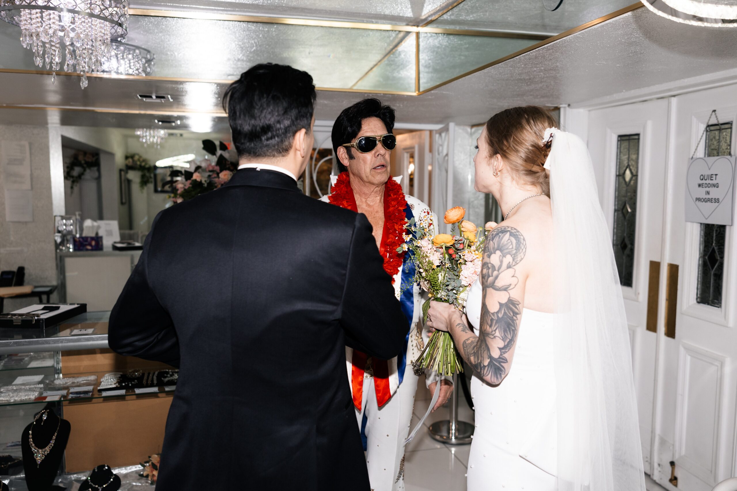 Bride and groom meeting Elvis impersonator at The Little White Chapel