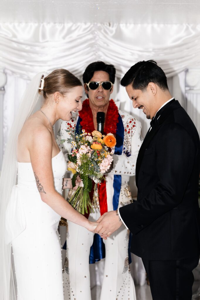 Bride and groom getting married by Elvis in Vegas at The Little White Chapel