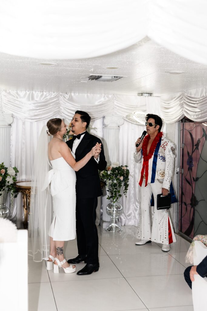 Bride and groom dancing during Elvis' performance at The Little White Chapel