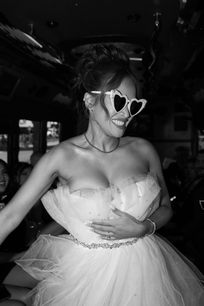 Black and white photo of a bride on a party bus