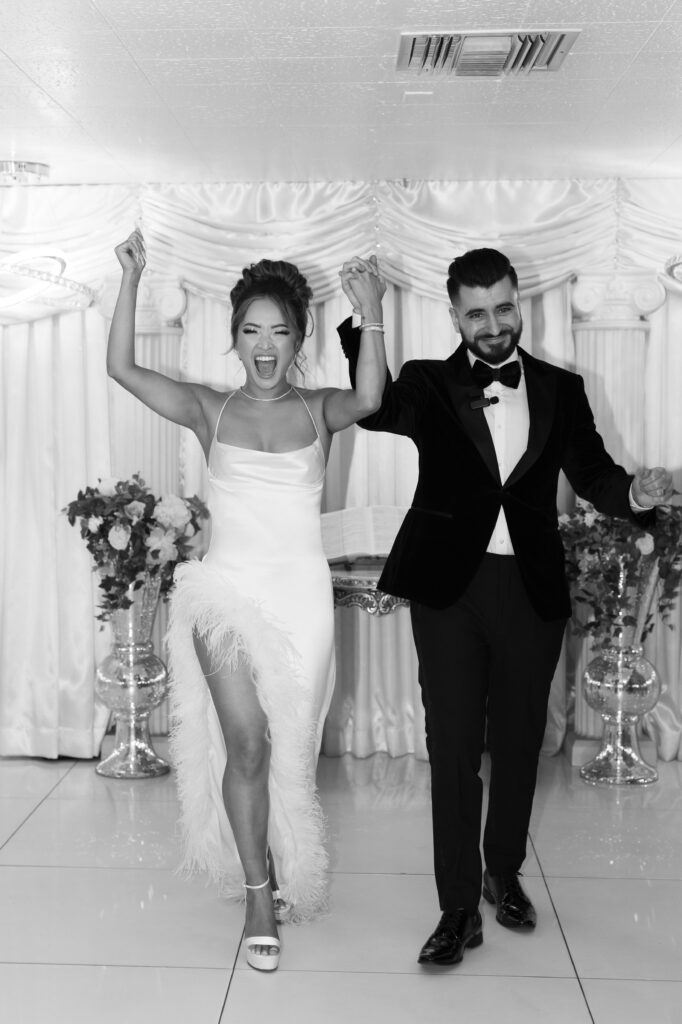 Bride and groom cheering after they just eloped at The Little White Chapel