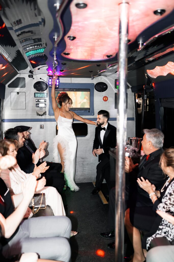 Bride and groom getting on their party bus