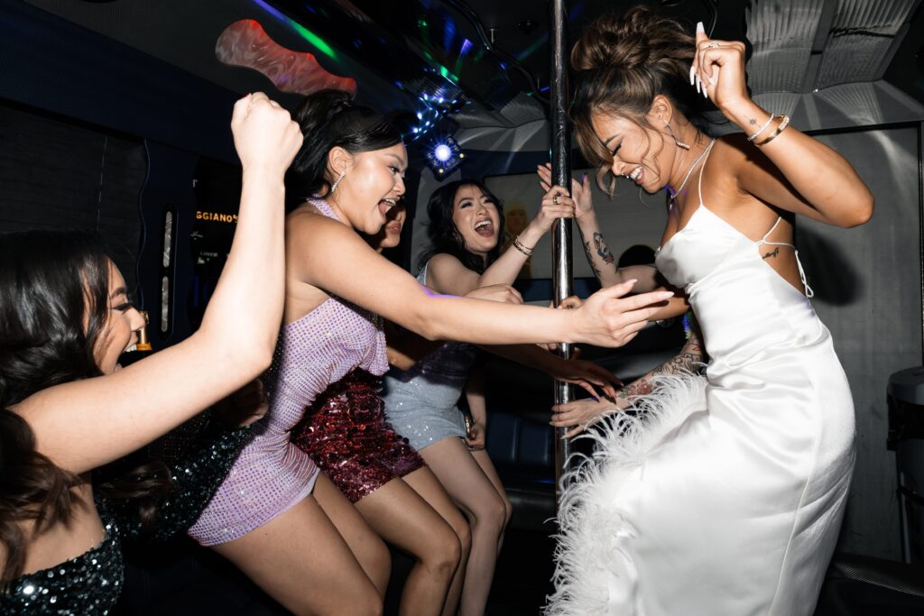 Bride and guests dancing on the wedding party bus