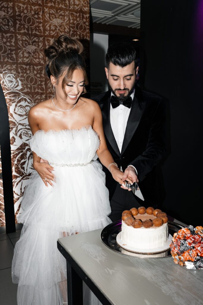 Bride and groom cutting into their Cinnabon delights cake during their Taco Bell Las Vegas wedding