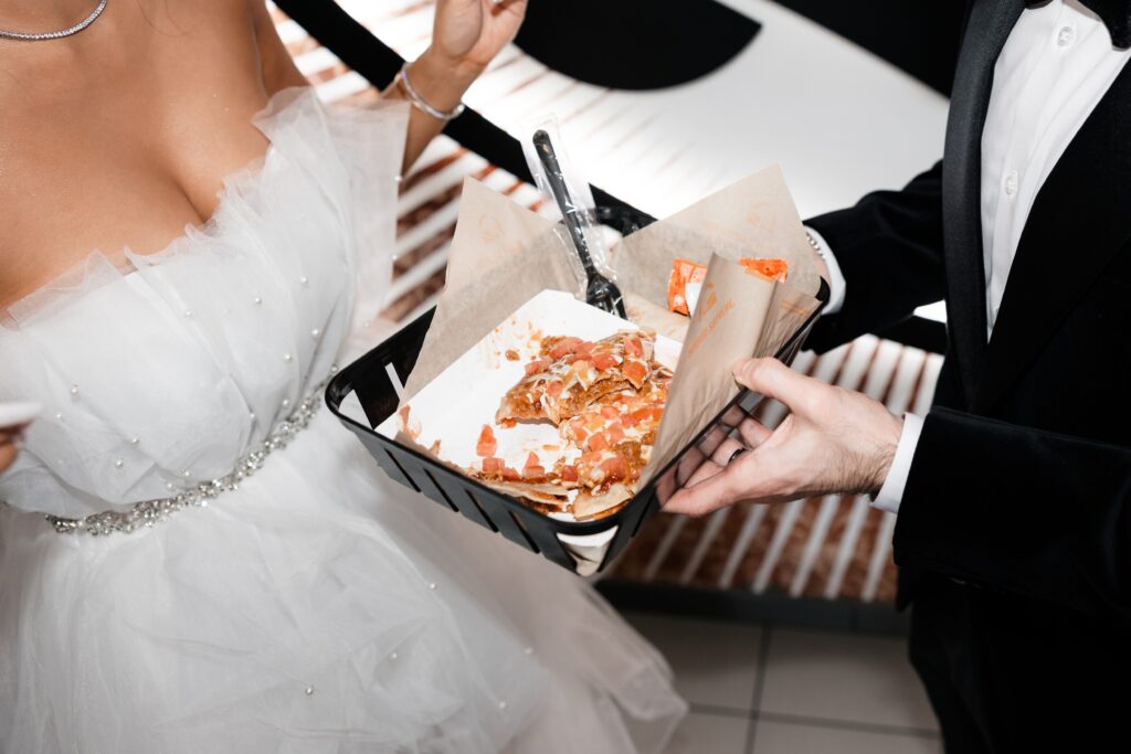 Bride and groom eating Mexican pizza after their Taco Bell Las Vegas wedding