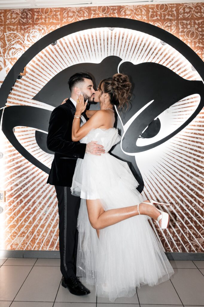 Bride and groom kissing for their Taco Bell Las Vegas wedding portraits