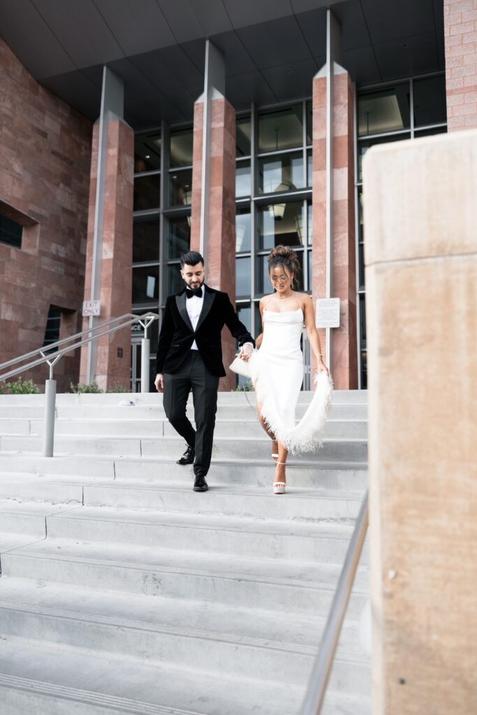 Bride ands groom walking down the steps of Clark County Marriage License Bureau