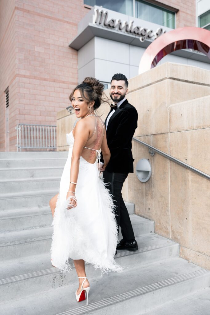 Bride and groom walking up the steps to the Clark County Marriage Bureau 
