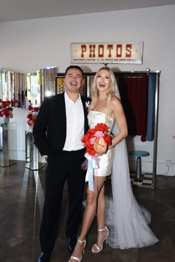 Bride and groom flash portraits in front of the vintage analog photo booth at Sure Thing Chapel in Las Vegas