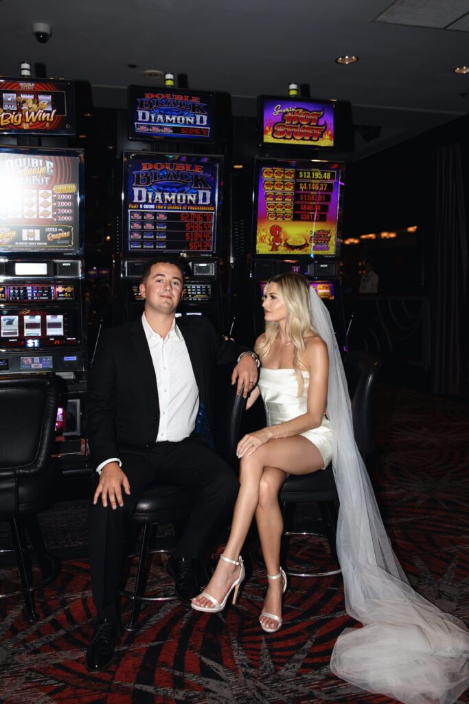 Bride and groom sitting at the slots at Fremont Casino